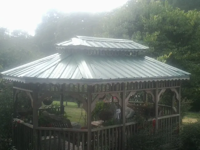 Two tier green metal roof on a garden gazebo in Tiltonsville
