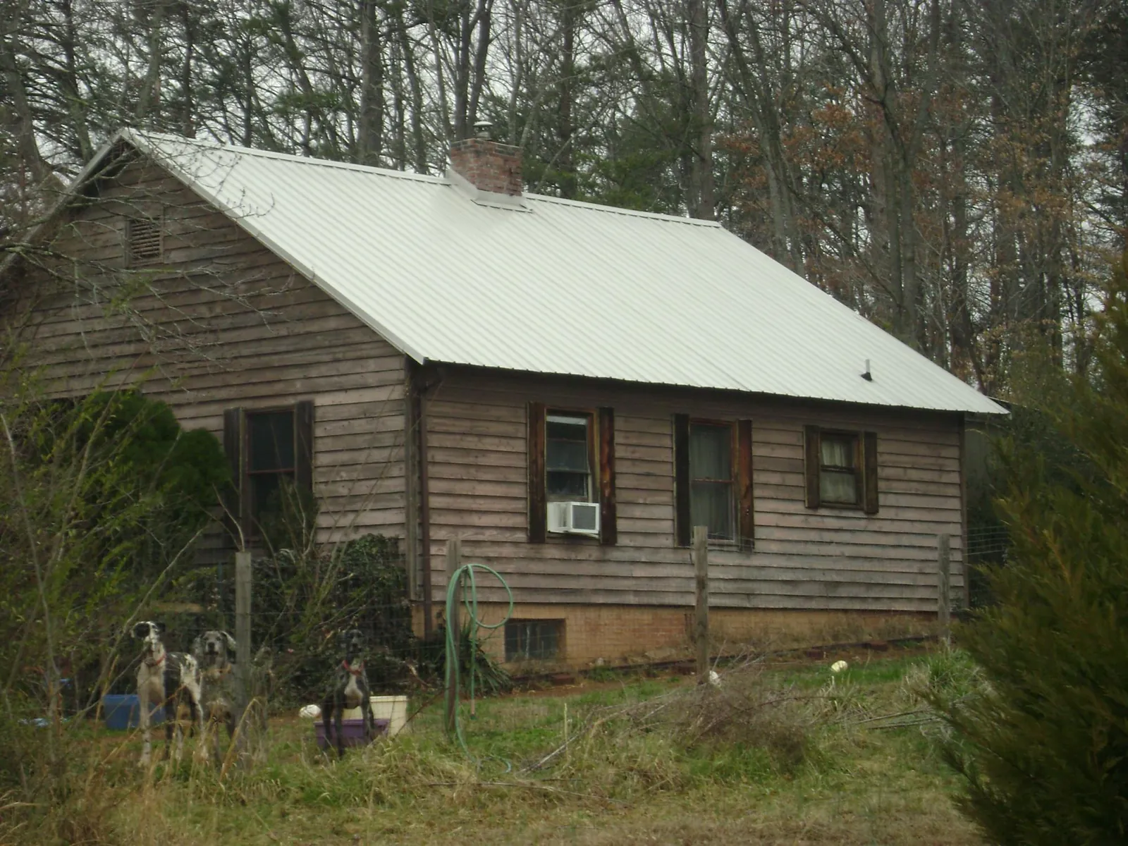 White metal roof on an old wood sided farmhouse, from a Metal Roof Installation job in Tiltonsville